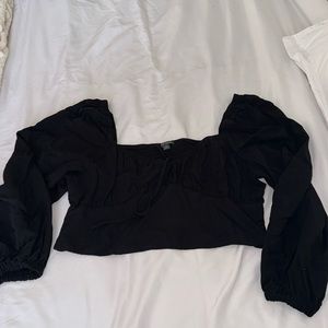 Black long sleeve, cropped corset top. Bell sleeves, adjustable front closure